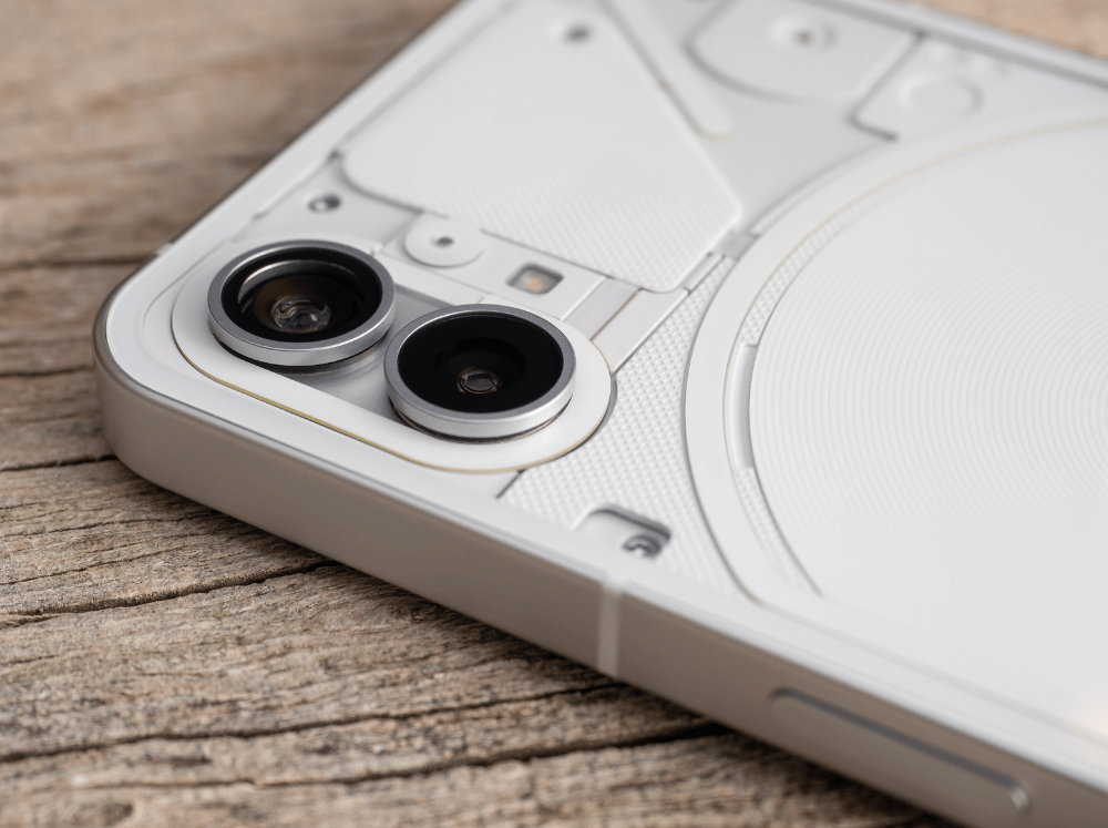 a light grey Nothing phone lying face down on a table